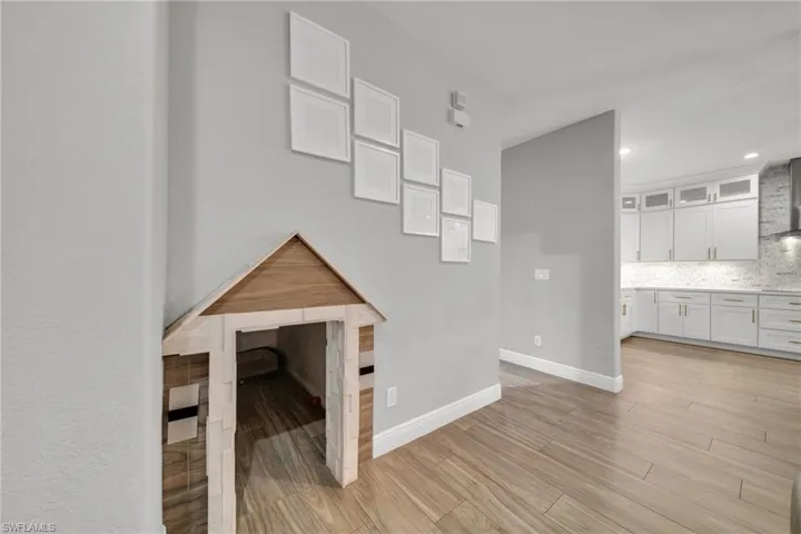 Unfurnished living room featuring baseboards, recessed lighting, and light wood-style floors