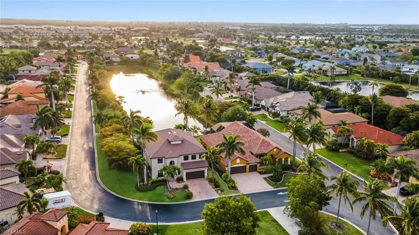 Birds eye view of property featuring a water view and a residential view
