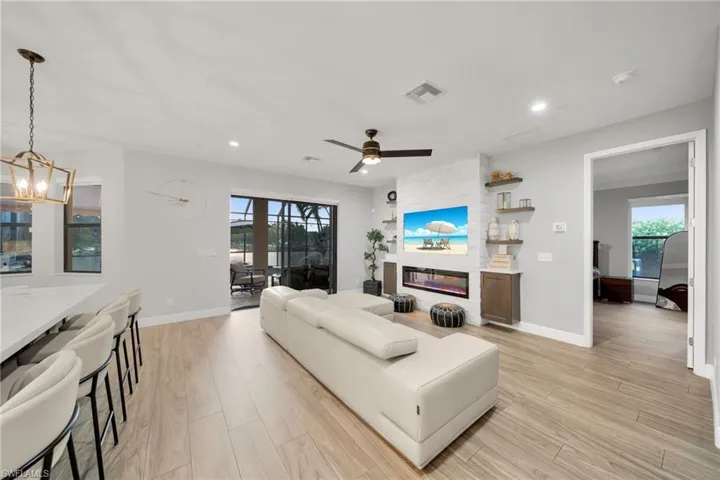 Living area featuring recessed lighting, light wood-type flooring, visible vents, and baseboards