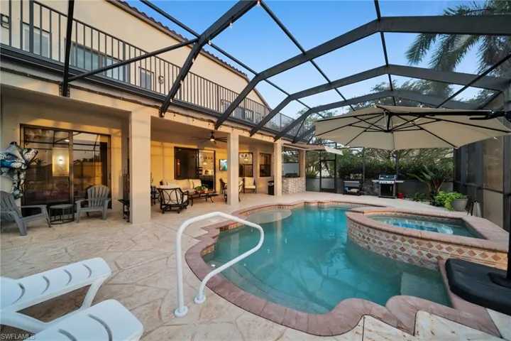 View of swimming pool featuring screen enclosure, a ceiling fan, area for grilling, a patio, and an outdoor hangout area