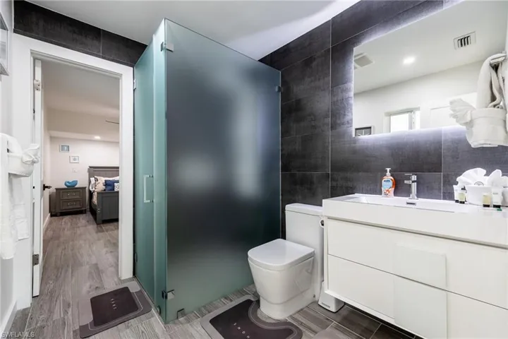 Primary Bathroom with vanity, a walk in shower, and connected bathroom