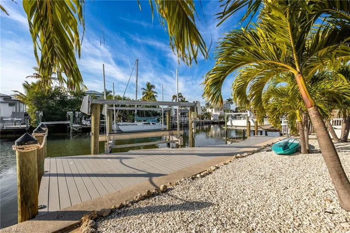 Dock featuring boat lift and a water view