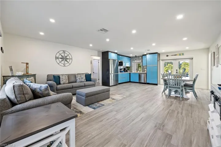 Living area with recessed lighting and light wood-style floors