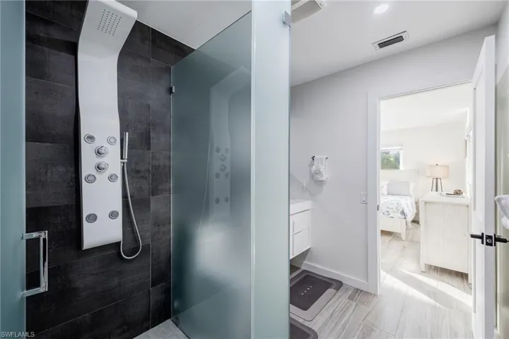 Primary Bathroom with vanity, a walk in shower, and connected bathroom