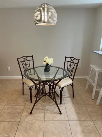 Dining room featuring light tile patterned flooring and baseboards
