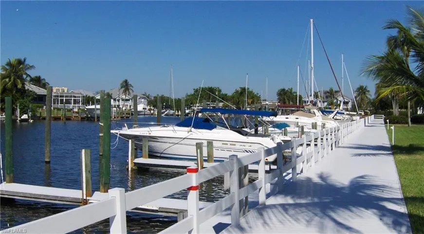 Dock area with a water view and boats