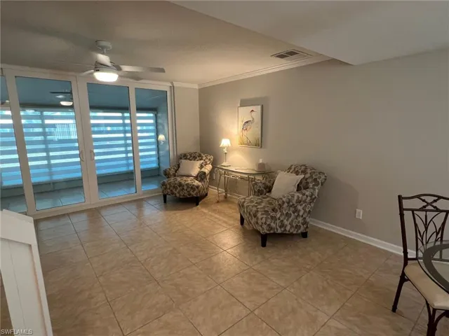 Livingroom leading out to the lanai,  ornamental molding and baseboards