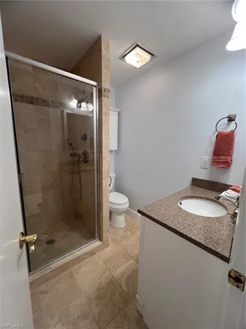 Bathroom featuring vanity and a shower