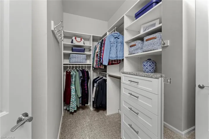 Custom finished master closet, more storage behind door on left