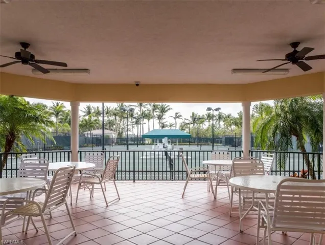 View of patio with a water view and ceiling fan