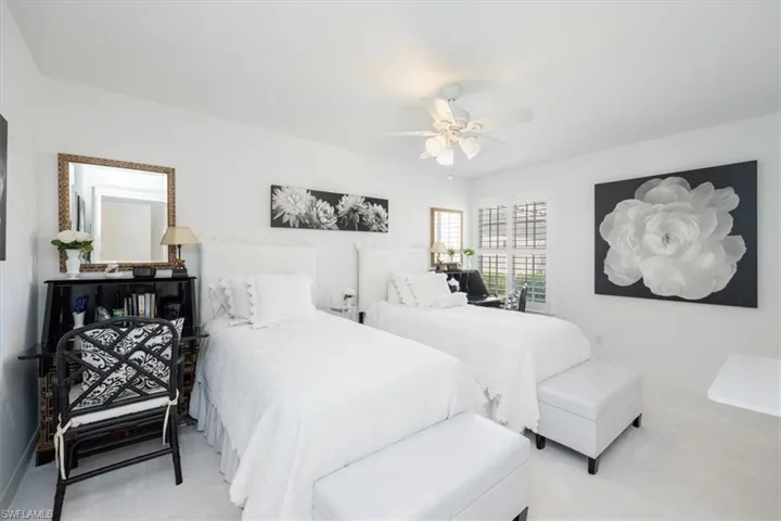 Carpeted bedroom with ceiling fan