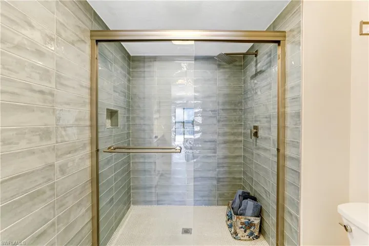 Custom tiled shower, glass shower doors