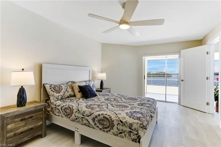 Primary bedroom with sliders out to balcony