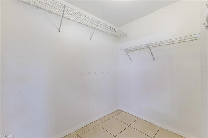 Spacious closet with light tile patterned floors