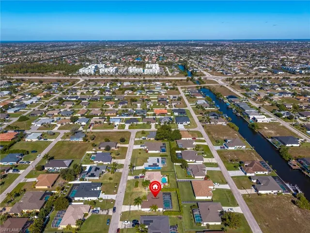 Aerial view of property's location featuring nearby suburban area and a large body of water