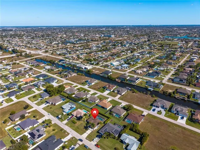 Aerial overview of property's location featuring nearby suburban area and a large body of water