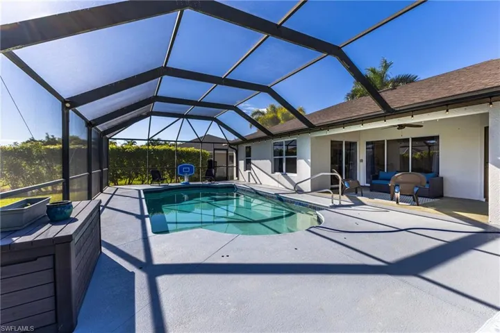 Outdoor pool with a lanai, a patio area, a sunroom, and an outdoor hangout area