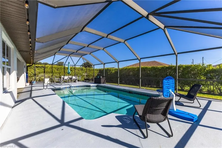 Swimming pool with a lanai, a patio, and a sunroom