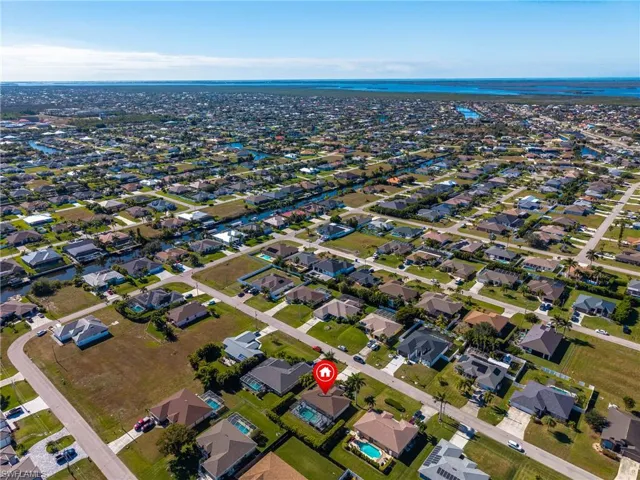 Aerial view of property's location with nearby suburban area and a large body of water