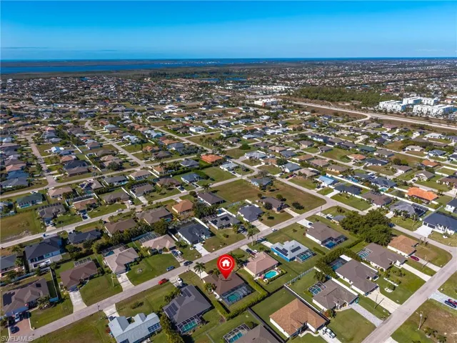 Aerial view of property's location with nearby suburban area