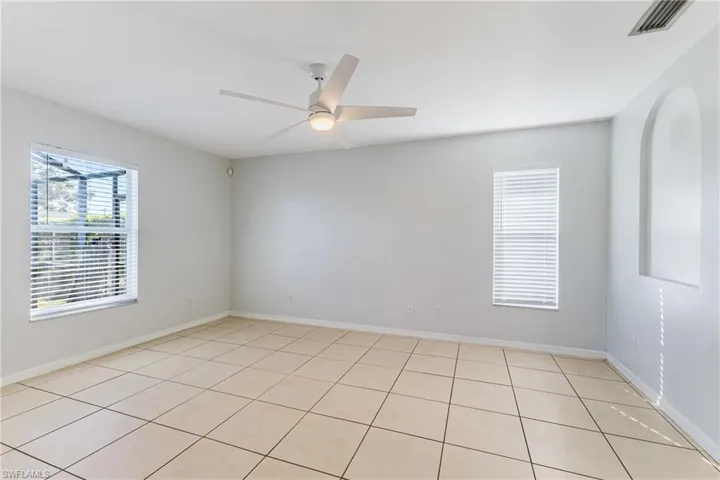 Unfurnished room with plenty of natural light, ceiling fan, and light tile patterned floors