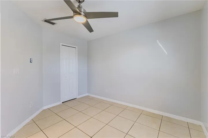 Unfurnished bedroom featuring a closet and ceiling fan
