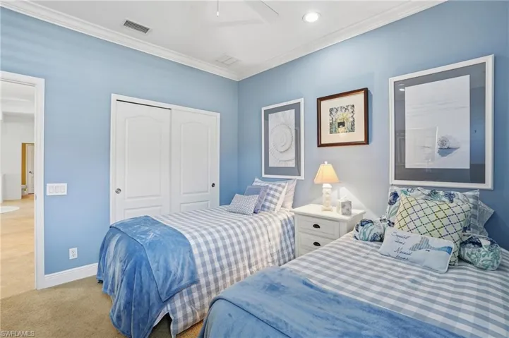 Carpeted bedroom with ornamental molding, a closet, recessed lighting, and a ceiling fan