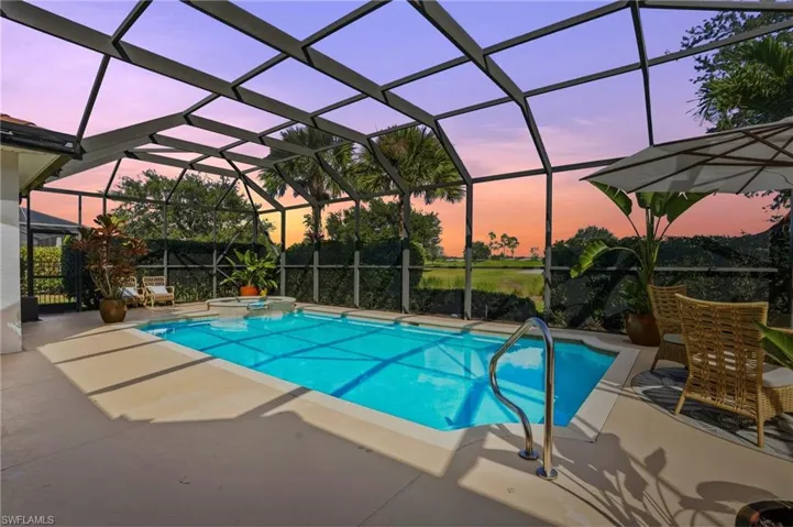 View of swimming pool, hot tub, and golf course