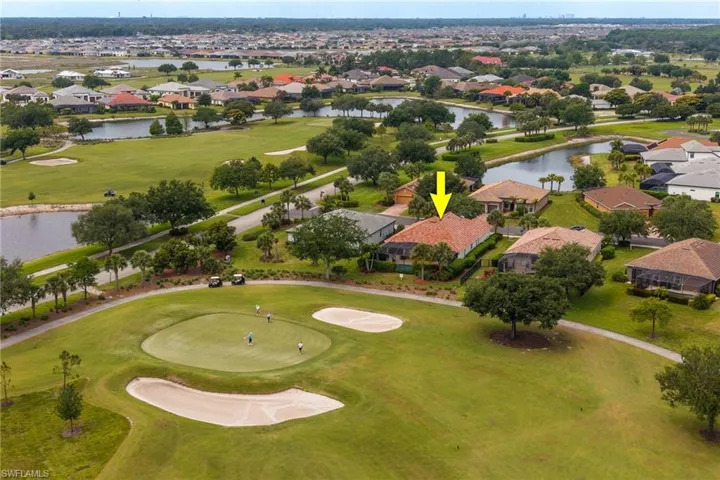 Aerial view of golf course and back of home.