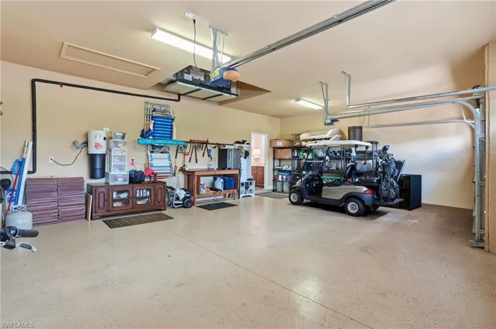Garage featuring a garage door opener and a workshop area
