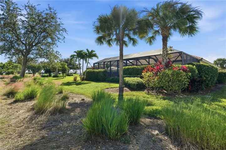 View of green lawn featuring a lanai