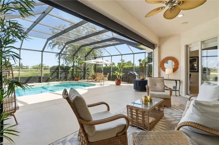 Swimming pool featuring a patio, ceiling fan, a sunroom, and a lanai
