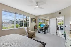Bedroom with a ceiling fan and carpet flooring