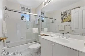 Full bath with enclosed tub / shower combo and vanity