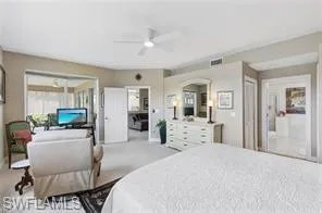 Carpeted bedroom featuring ceiling fan