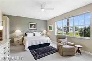 Bedroom with light carpet and a ceiling fan