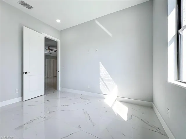 Empty room featuring ceiling fan