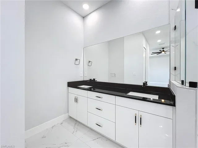 Bathroom featuring vanity and ceiling fan