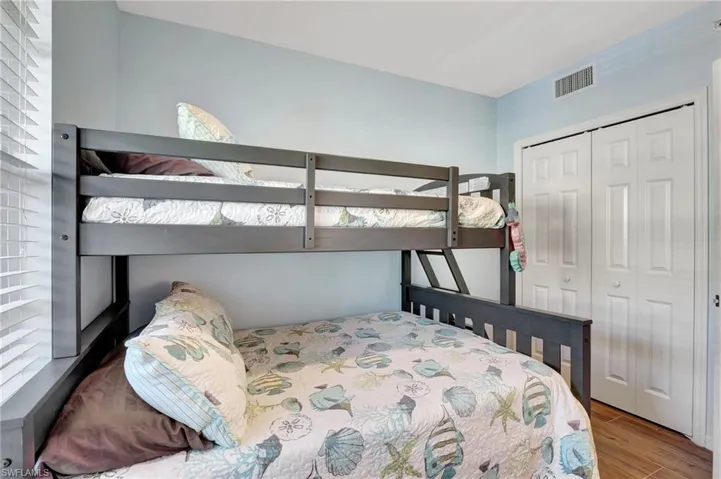 Bedroom with light wood-type flooring and a closet