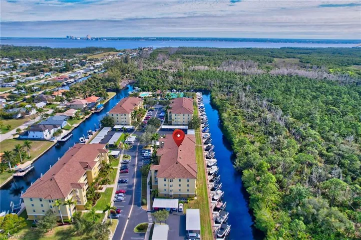 Birds eye view of property with a water view