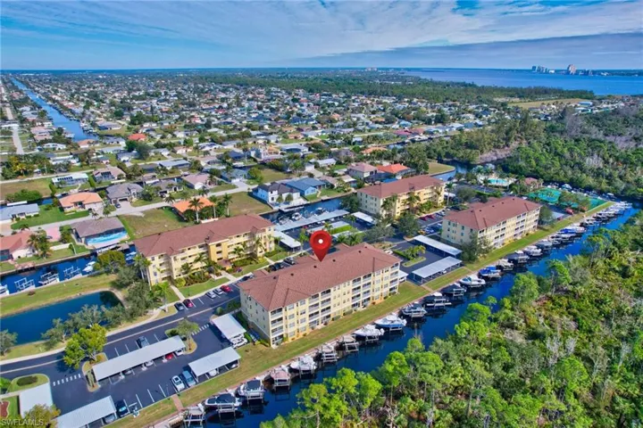 Birds eye view of property with a water view