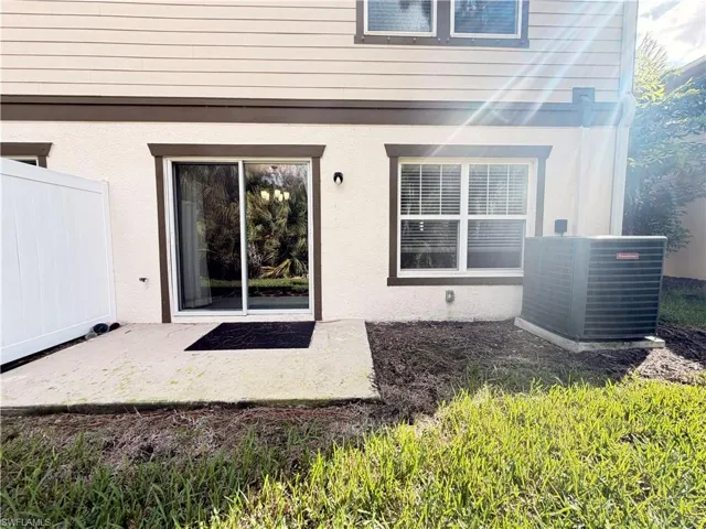 View of exterior entry with a patio and stucco siding