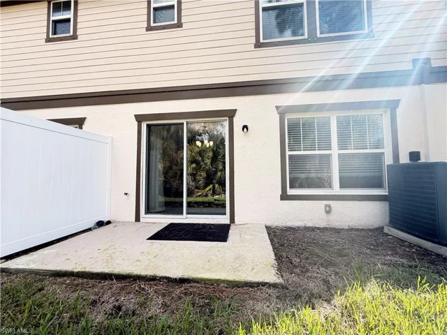 View of exterior entry with a patio area