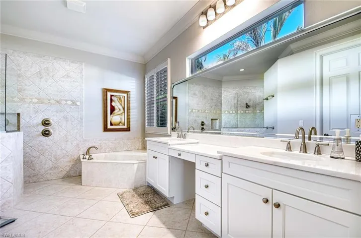 Full bath featuring walk in shower, a garden tub, ornamental molding, double vanity, and light tile patterned floors