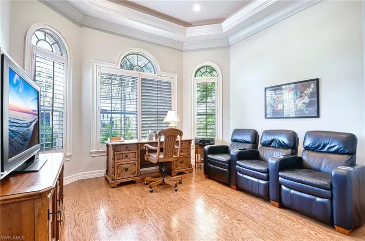 Home office with light wood-style flooring and ornamental molding