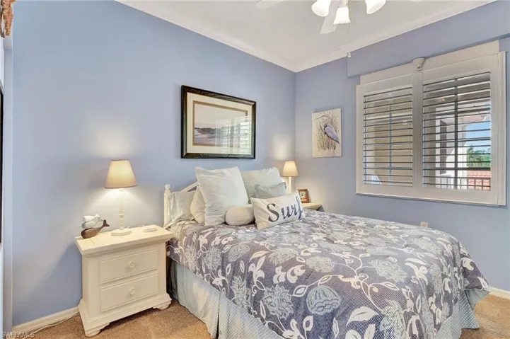 Bedroom featuring new  light carpet, a ceiling fan, and crown molding