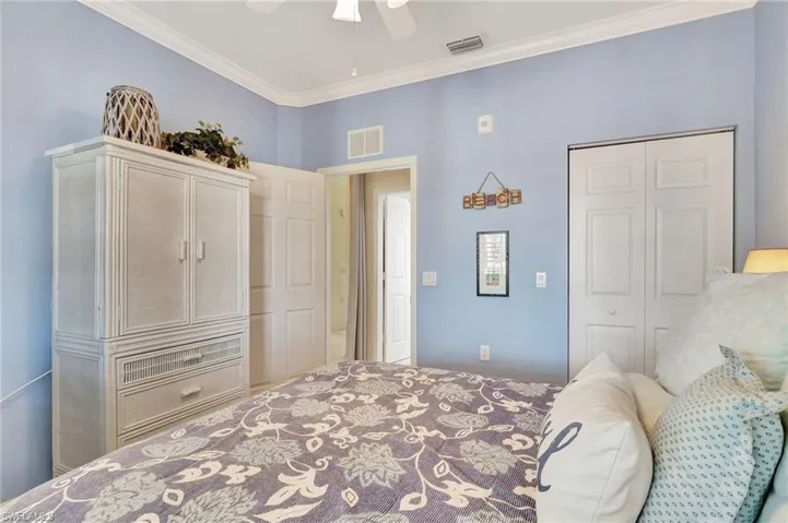 Bedroom with crown molding, and ceiling fan
