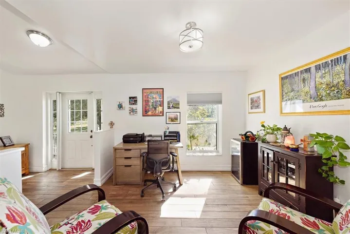 Office space featuring light wood-style floors and baseboards