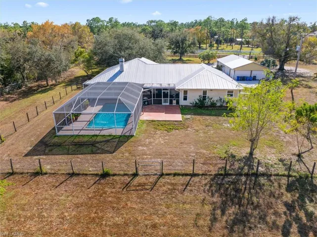 Bird's eye view of a pool and a tree filled landscape