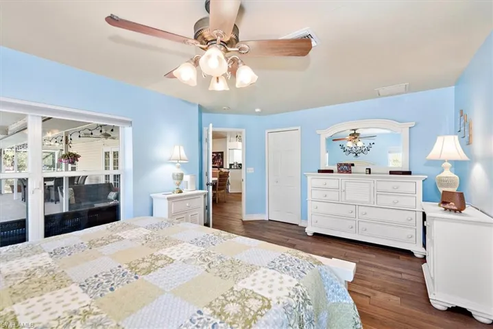 Bedroom with dark wood-type flooring and ceiling fan